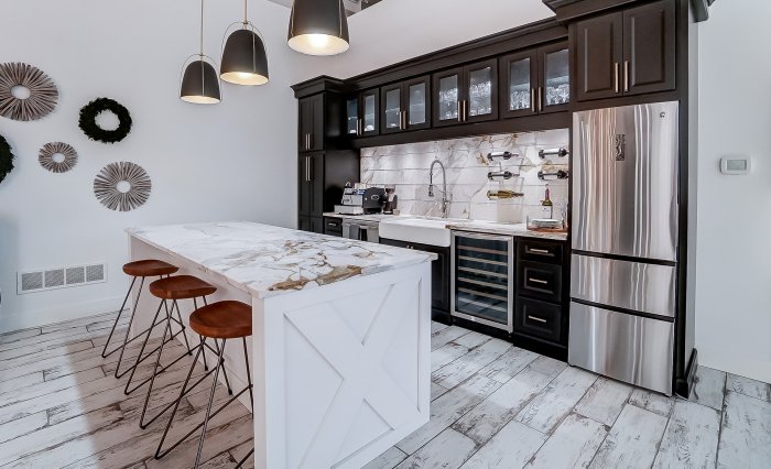 Waterfall kitchen island with thick quartz countertop in a modern kitchen